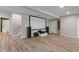 Finished basement featuring wood-look flooring, home theater setup, and access to an adjacent bathroom and utility space at 12811 Corydon Dr, Fishers, IN 46037