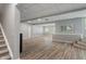 Unfinished basement space featuring wood flooring and natural light at 12811 Corydon Dr, Fishers, IN 46037