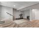Finished basement featuring stairs, wood floors, and exercise equipment at 12811 Corydon Dr, Fishers, IN 46037