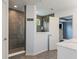 Bathroom featuring a walk-in shower, gray tiling, and a window at 12811 Corydon Dr, Fishers, IN 46037