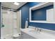 Bathroom featuring a glass shower, vanity, and blue walls at 12811 Corydon Dr, Fishers, IN 46037
