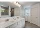 Bathroom featuring double sinks, a window, and a walk-in shower with gray tiling at 12811 Corydon Dr, Fishers, IN 46037