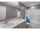 Bathroom featuring double sinks, framed mirror, and shower over tub at 12811 Corydon Dr, Fishers, IN 46037