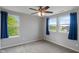 Bright bedroom featuring two windows, ceiling fan, and neutral carpeting at 12811 Corydon Dr, Fishers, IN 46037