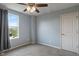 Bedroom with blue walls, neutral carpet, a ceiling fan, and a window with a view of the neighborhood at 12811 Corydon Dr, Fishers, IN 46037