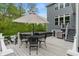 Enjoy outdoor living on this elevated deck with seating, dining area, grill, hot tub, and scenic backyard views at 12811 Corydon Dr, Fishers, IN 46037