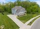 Beautifully appointed home with ample driveway space, a two-car garage, and verdant landscaping at 12811 Corydon Dr, Fishers, IN 46037