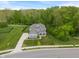 Charming home nestled on a spacious lot with lush greenery, long driveway, and well-manicured lawn at 12811 Corydon Dr, Fishers, IN 46037
