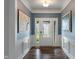 Inviting foyer with dark wood floors, paneled walls, and decorative artwork at 12811 Corydon Dr, Fishers, IN 46037
