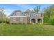 Charming two-story home with a stone facade, covered entryway, and lush green lawn at 12811 Corydon Dr, Fishers, IN 46037