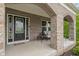 Charming front porch with brick archway, seating area, and stylish black front door for a welcoming entrance at 12811 Corydon Dr, Fishers, IN 46037