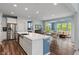 Open kitchen with stainless steel appliances, a large island, and views of the breakfast area at 12811 Corydon Dr, Fishers, IN 46037