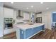 Modern kitchen featuring white cabinets, stainless steel appliances, and a large center island at 12811 Corydon Dr, Fishers, IN 46037