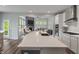 Modern kitchen with an expansive island, stainless steel appliances, and seamless flow to the living spaces at 12811 Corydon Dr, Fishers, IN 46037