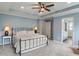 View of main bedroom with a ceiling fan, a queen bed, two bedside tables, and an ensuite bathroom at 12811 Corydon Dr, Fishers, IN 46037