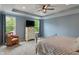 Spacious main bedroom with a large bed, dresser, ceiling fan, and many windows at 12811 Corydon Dr, Fishers, IN 46037