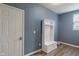 View of the mudroom with blue walls, a white storage bench, and a white door at 12811 Corydon Dr, Fishers, IN 46037