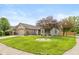Lovely single-story home features brick accents, manicured lawn, and a two-car garage at 1283 Easton Point Dr, Greenwood, IN 46142