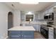 Well-lit kitchen with gray cabinets, stainless steel appliances, quartz countertops, and center island at 1283 Easton Point Dr, Greenwood, IN 46142