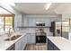 Bright kitchen with stainless steel appliances, quartz countertops, and gray cabinets at 1283 Easton Point Dr, Greenwood, IN 46142