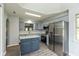 Stylish kitchen with stainless steel appliances, a center island, gray cabinets, and sleek countertops at 1283 Easton Point Dr, Greenwood, IN 46142