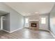 Bright living room featuring a brick fireplace and two exterior doors at 1283 Easton Point Dr, Greenwood, IN 46142