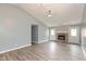 Open-concept living room showcasing a cozy brick fireplace, wood floors, and ample natural light at 1283 Easton Point Dr, Greenwood, IN 46142