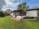 Beautiful backyard featuring a sunroom, lush green lawn, privacy fence, and landscape at 1513 Ashley Dr, Lebanon, IN 46052