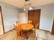 Cozy dining room with wood-style flooring, a wooden table, and a stylish light fixture at 1513 Ashley Dr, Lebanon, IN 46052