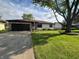 Charming single-story home with a stone and siding exterior, an attached garage, and a well-manicured lawn at 1513 Ashley Dr, Lebanon, IN 46052