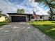 Charming single-story home with a stone and siding exterior, an attached garage, and a well-manicured lawn at 1513 Ashley Dr, Lebanon, IN 46052