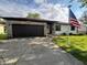 Charming single-story home with a stone and siding exterior, an attached garage, and a well-manicured lawn at 1513 Ashley Dr, Lebanon, IN 46052