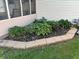 Beautiful garden with diverse plants, mulch, and stone edging, creating a serene outdoor space at 1513 Ashley Dr, Lebanon, IN 46052