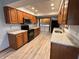 Traditional eat-in kitchen with granite countertops and wood cabinets, offering a functional layout at 1513 Ashley Dr, Lebanon, IN 46052