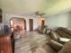 Spacious living room featuring new floors, a ceiling fan, and comfortable furnishings at 1513 Ashley Dr, Lebanon, IN 46052