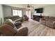 Comfortable living room featuring new floors, a ceiling fan, and a cozy fireplace at 1513 Ashley Dr, Lebanon, IN 46052