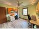 Functional office space with a ceiling fan and built-in storage solutions, perfect for productivity at 1513 Ashley Dr, Lebanon, IN 46052