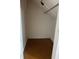 Unfinished attic space with sloping ceilings, storage and utility lighting at 1618 California St, Columbus, IN 47201