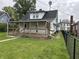 Exterior back view of home featuring a large covered back porch with stairs at 1618 California St, Columbus, IN 47201