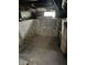 A basement with a concrete floor, white walls, and a small window in the background at 1618 California St, Columbus, IN 47201