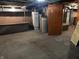 Unfinished basement with exposed ductwork, water heater and concrete walls and floors at 1618 California St, Columbus, IN 47201