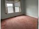 Bedroom with a window and pink carpet at 1618 California St, Columbus, IN 47201
