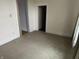 Neutral bedroom featuring carpet, an adjacent room with floral wallpaper, and an open closet at 1618 California St, Columbus, IN 47201