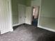 Carpeted bedroom featuring painted walls and white trim with doorways into other rooms at 1618 California St, Columbus, IN 47201