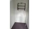 A small closet with purple carpet and decorative metal shelving against a white wall at 1618 California St, Columbus, IN 47201