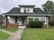Traditional home with dark roof, red brick accents, covered porch, and well-maintained front lawn at 1618 California St, Columbus, IN 47201