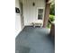 Covered front porch featuring brick accents, white siding, and stone bench at 1618 California St, Columbus, IN 47201