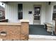 Close up of front porch featuring red brick accents, house number, and stone bench at 1618 California St, Columbus, IN 47201