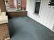 Covered front porch featuring brick accents, white siding, and blue carpet at 1618 California St, Columbus, IN 47201