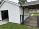 Detached garage has a car port and fence that adds functionality and security at 1618 California St, Columbus, IN 47201